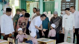 Reza Fahlevi saat menyapa salah satu murid SD