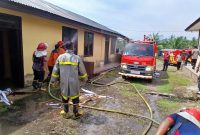 Petugas pemadam kebakaran menyiram ruangan kantor Bhayangkari Polsek Pandrah terbakar, Selasa (21/4/2026) pagi.