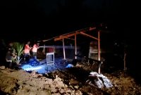 Petugas pemadam menyiram dapur masak/sale kopra yang terbakar di Gampong Cot Bada, Kecamatan Jeumpa, Rabu (29/7) malam
